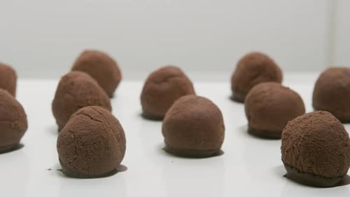 Chocolate Truffles on a Conveyor Belt at Candy Factory Bakery