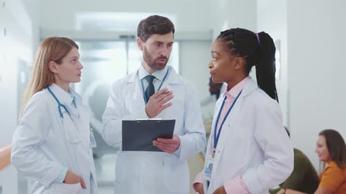Medical Professionals Discussing Patient Care in Hospital Hallway