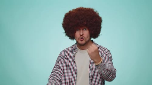 Man with an Afro Play-Fighting and Boxing