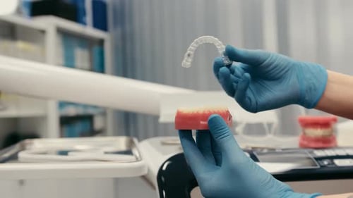 The Doctor Shows How to Put on a Dental Mouth Guard a Splint for the Treatment of Dysfunction of the