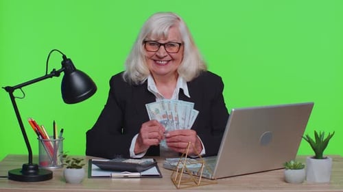 Senior Business Office Woman Accountant or Banker Making Money Cash Calculations Income Earnings