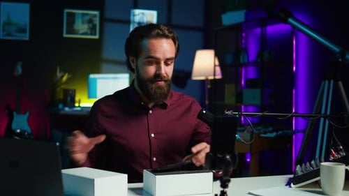 Man Records Technology Review for Vlog at Desk