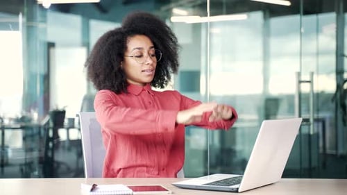 Happy young african american female employee finished work on laptop sitting in business office.