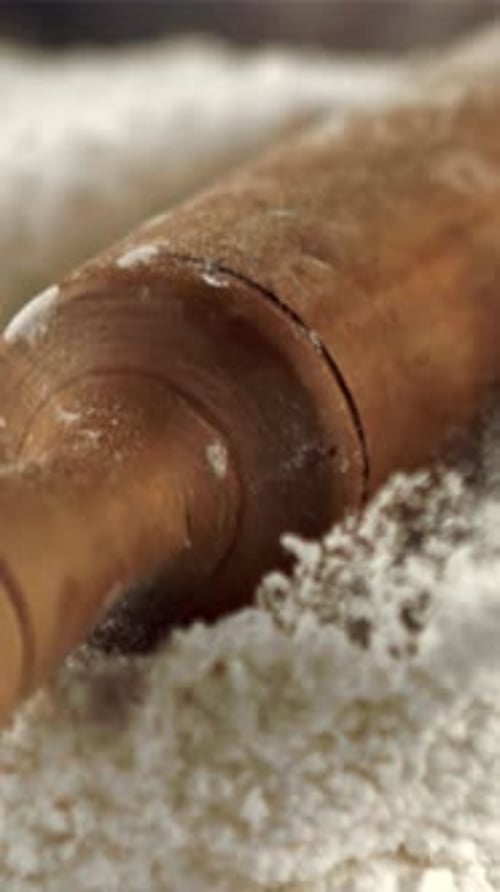 The Super Slow Motion of the Wooden Rolling Pin Falls Into the Flour Filmed on a Highspeed Camera at