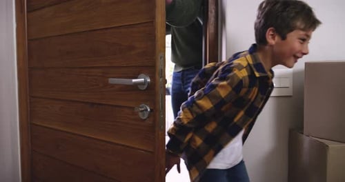 Family Moves Into New Home With Boxes