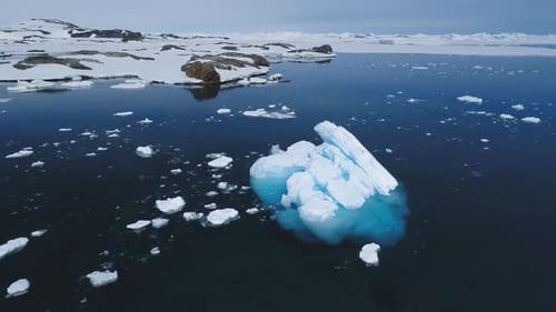 Aerial Flight Over Antarctic Iceberg Amid Ocean