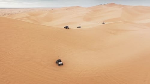 Group of Four Wheel Drive Vehicles Competing on Dunes ATV Buggy Riding Fast