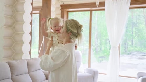 Toddler and Mother Wave Goodbye in a Light Home