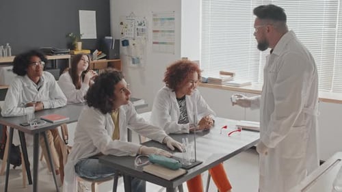 Science Class with Teacher Explaining Experiment to Students