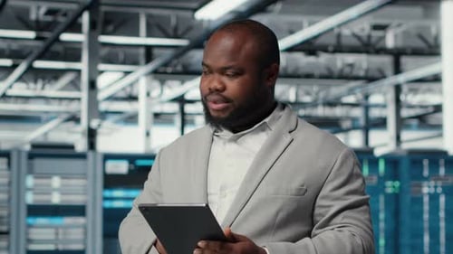 IT Expert in Industrial Data Center Analyzing Infrastructure Performance