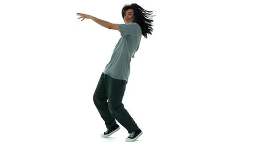 Young hip hop dancer performing slow motion moves in a white studio