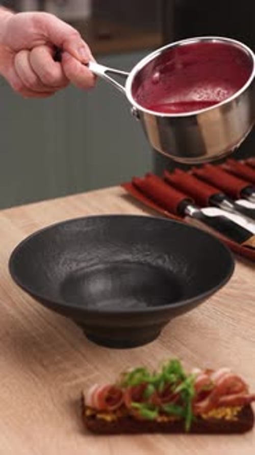 The chef is preparing a puree soup in the kitchen. Close-up