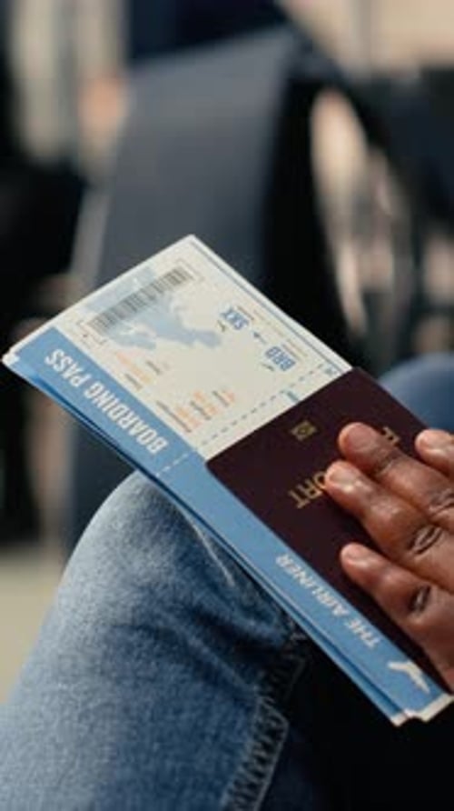 Vertical Video Plane Ticket and Passport Close Up Flight Details in Airport Departure Area