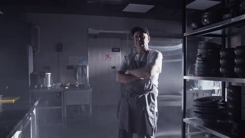 Adult Chef Standing in Commercial Kitchen with Arms Crossed