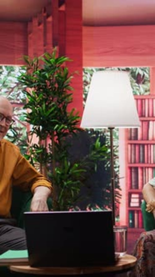 Adults Video Conferencing From Home on Laptop