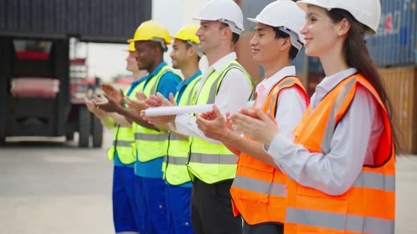 Group of man and woman worker clap hands while work in container port ...