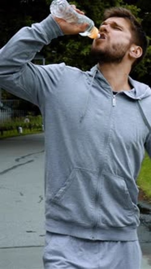 Bearded Man Drinking Water During Outdoor Workout