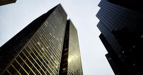 Skyscrapers Reflect Light in a Bustling Urban Setting on a Cloudy Day