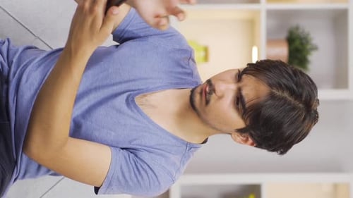 Man Using Smartphone Indoors in Portrait Orientation