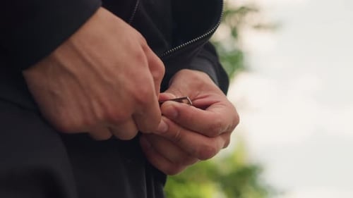 Closeup of Hands Fastening Zipper Outdoors Caucasian Male Performing Zipper Fastening Gesture with