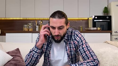 Man is Talking on Phone in his Home