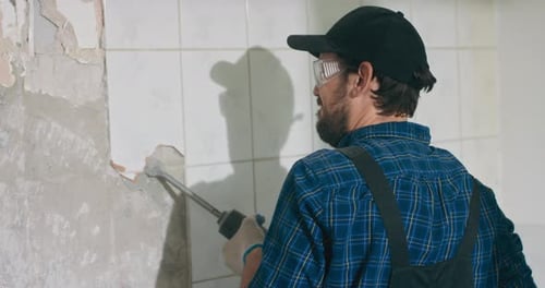 Closeup Portrait of Face of Exhausted Tired Man in Work Overalls and Baseball Cap Working on Home
