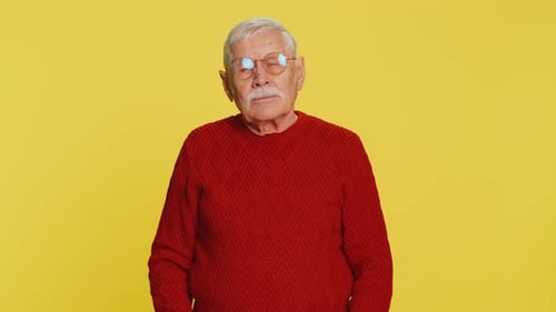 Senior Man Rubs Tired Eyes