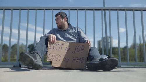 Homeless Man Expressing Struggles By Bridge in Financial Crisis