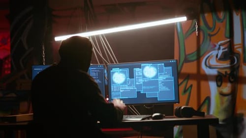 Hacker in Dark Neon Lit Underground HQ Coding Malware