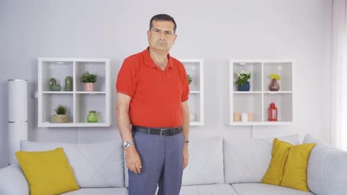 Elderly man looking at camera with negative expression.