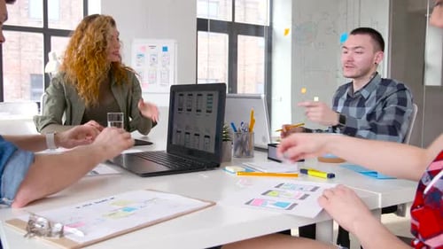 Team Collaborating on Mobile App Design in Office