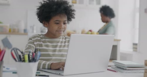 Child Using Laptop for Home Education
