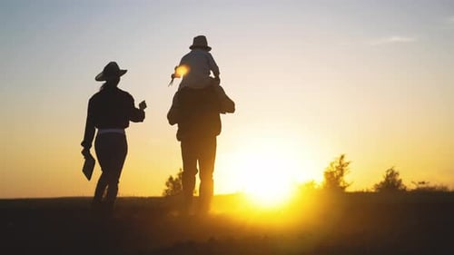 Farmers Family in Countryside in Sunset Silhouette Back View Happy Parents Childhood Moments