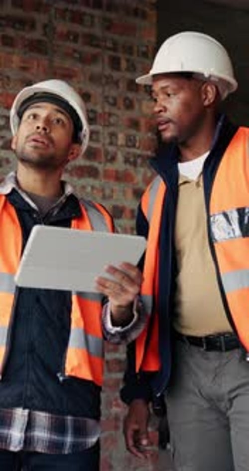 Civil engineer, inspection and men with tablet in building, collaboration