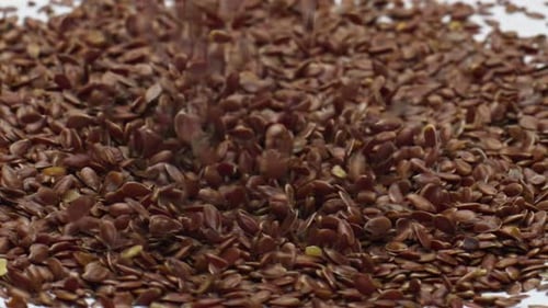 Flax Seeds Falling into Yogurt Cream