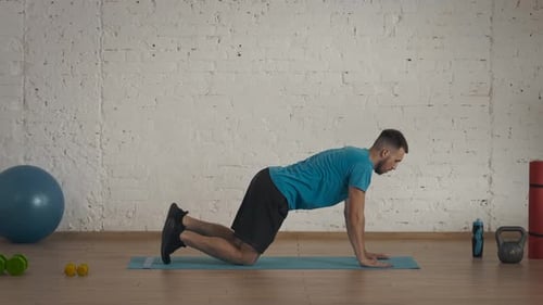 Man Fitness Coach in Sportswear Doing Back Body Strengthening Exercise for Online Class at the Home