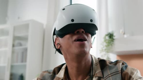 Man Experiencing Virtual Reality with Headset and Controllers