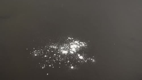 White Powder Falling onto Gray Surface