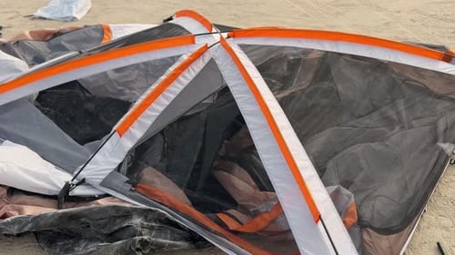 Collapsed Camping Tent Roof and Mesh Panels on Sandy Lot