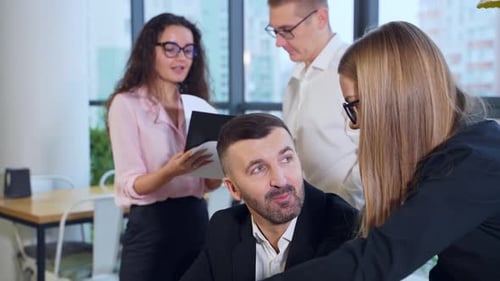 Business Team Discussing Documents in Modern Office