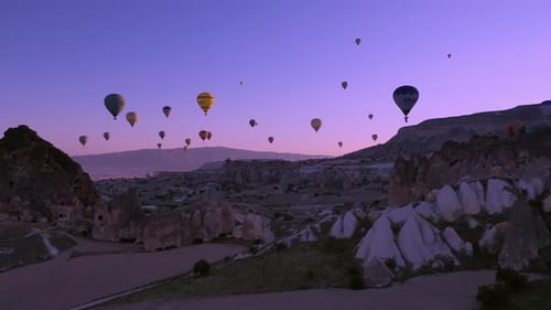 Hot Air Balloons Soaring over Breathtaking Valley at Sunrise