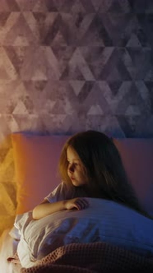 Little Child Wipes Nose Looking at Illuminated Play Teepee