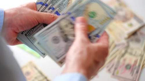 Hands Counting One Hundred Dollar Bills