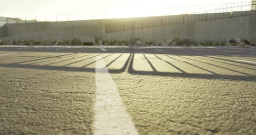 Shadows Stretch Across an Empty Parking Lot at Sunset in a Tranquil Setting