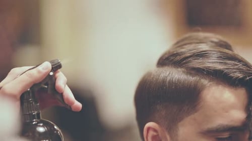 Man getting trendy haircut at salon
