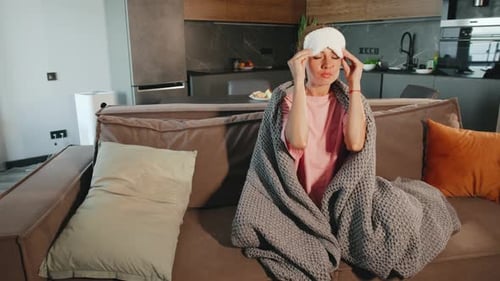 Woman with Sleep Mask Resting on Couch