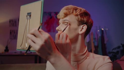 Young Adult Applies Makeup with Brush in Home Interior