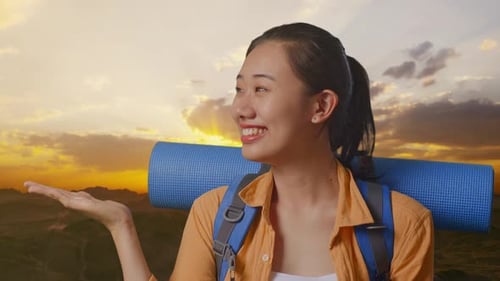 Close Up Of Asian Female Hiker Smiling And Pointing To Side On The Top Of Mountain