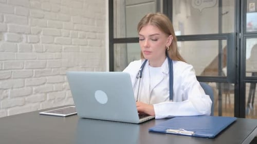 Female Doctor Smiling at Camera in Hospital