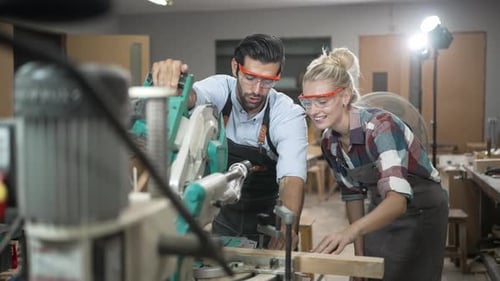 Carpenters are working together at workshop.